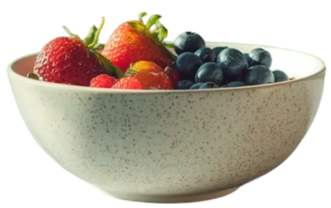A speckled ceramic bowl filled with fresh strawberries and blueberries, showcasing vibrant colors and healthy fruit, set against a neutral background.